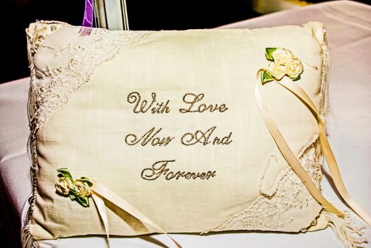 wedding and diamond engagement rings on silk presentation cushion UK