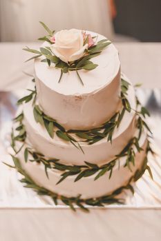 Wedding rustic white cake with flowers and leaves