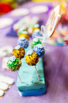 Candy bar on child birthday party. Decorated table with colorful cake pops for the guests.