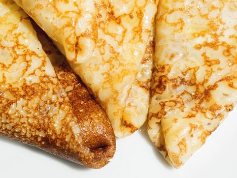 Freshly cooked pancakes, a traditional dish of Russian cuisine for Maslenitsa celebration - holiday of the end of winter. Tasty pastry.