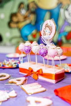 Candy bar on child birthday party. Decorated table with colorful cake pops for the guests.