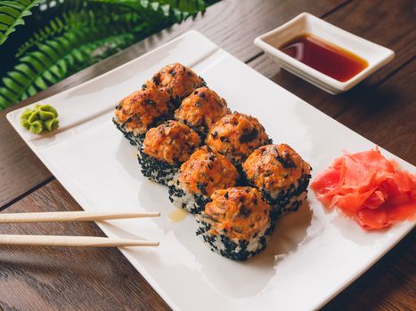 Rolls with eel, shiitake mushrooms, black sesame, spicy sauce, unagi sauce, pickled ginger. Asian cuisine, traditional dish - sushi.