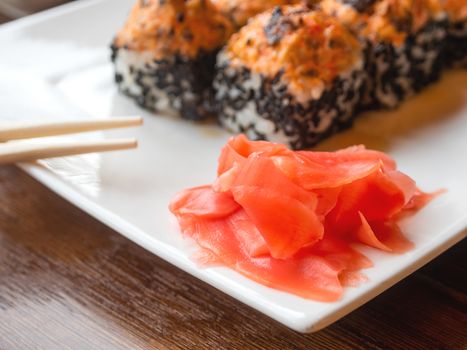 Pickled ginger and rolls with eel, shiitake mushrooms, black sesame, spicy sauce, unagi sauce. Asian cuisine, traditional dish - sushi.