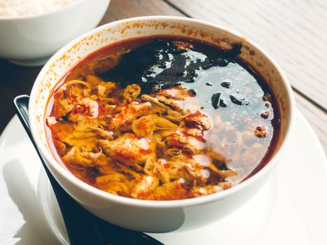 Asian cuisine - Kimchi soup in white bowl with rice. Close up photo.
