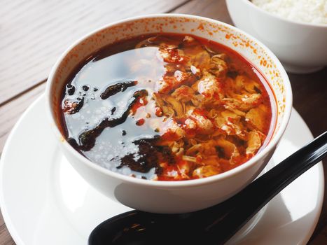 Asian cuisine - Kimchi soup in white bowl with rice. Close up photo.