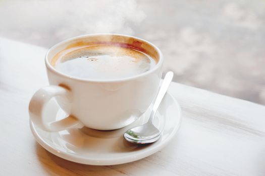 Cup of hot coffee. Hot tasty americano in white mug.