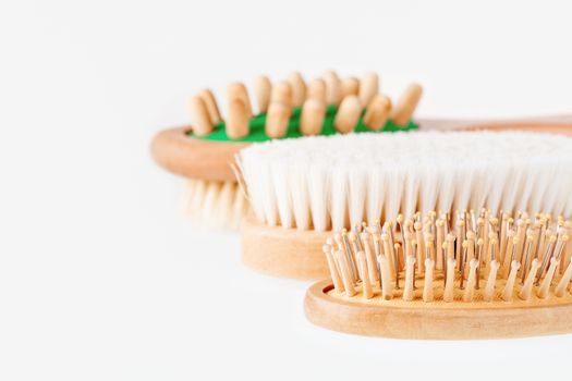 Three combs on white background. Different types of massage and hair brushes.