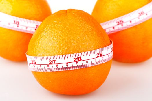 Three oranges with tailor's ruler. Orange diet. Fruit healhy vitamin diet helps to lose weight.