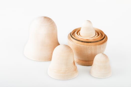 Set of clear wooden nesting dolls. Russian traditional toy, named matryoshka, on white background. Copy space.