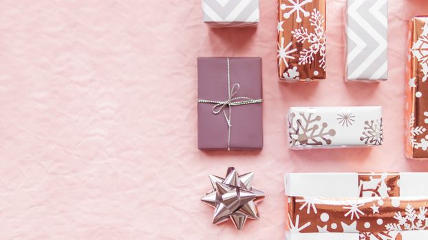 Valentine's Day presents with golden decorations. Gift boxes on pink crumpled paper background with copy space.