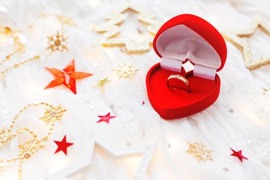 Christmas and New Year holiday background with decorations and engagement ring in gift heart box. Valentine's Day card.