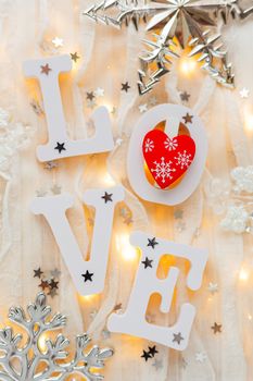 Valentine's Day background with word LOVE, decorations and light bulbs. Red heart - symbol of love.