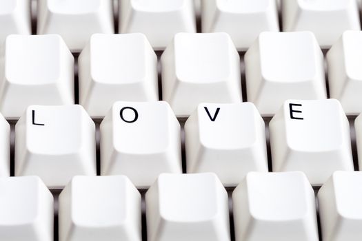 Word LOVE on computer keyboard with empty space on other buttons. May be used as symbol of love on the Internet, love e-mail letters.