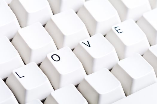 Word LOVE on computer keyboard with empty space on other buttons. May be used as symbol of love on the Internet, love e-mail letters.