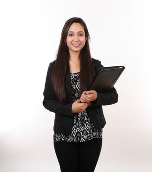 A young woman in a black suit holds her portfolio as she smiles.