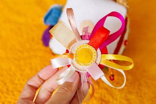 Colorful hand made toy for toddlers and babies. Busy cube. Soft baby block made of fabric to develop skills and fine motor skills. Taggie Cube. Montessori busy toy.