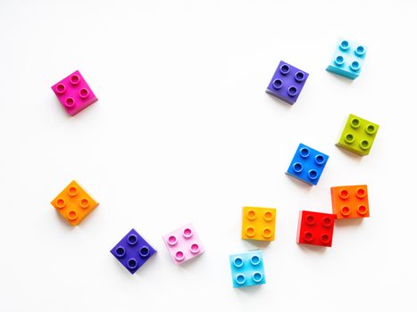 Colorful constructor blocks. Toy bricks lyingwithout order. Place for text among multicolored toy details.