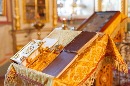 Golden religious utensils - Bible, cross, prayer book, missal . Details in the Orthodox Christian Church. Russia.