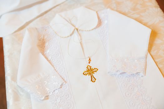 Laced dress for christening. Elegant outfit for little baby. Russian Orthodox church ceremony details.