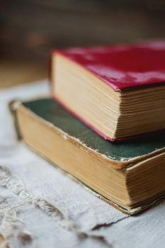Two old books on homespun napkin. Interesting reading, vintage background.