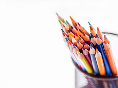 Bunch of colorful watercolor pencils on white background. School supplies. Kid's stationery with copy space. Back to school backdrop.