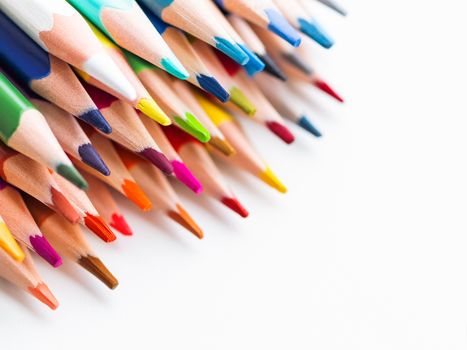 Row of colorful watercolor pencils on white background. School supplies. Kid's stationery with copy space. Back to school backdrop.