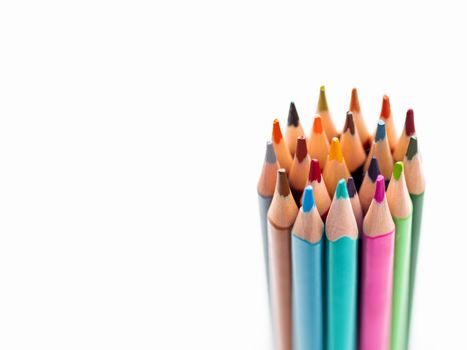 Bunch of colorful pencils on white background. School supplies on white background. Kid's stationery. Back to school copy space backdrop.