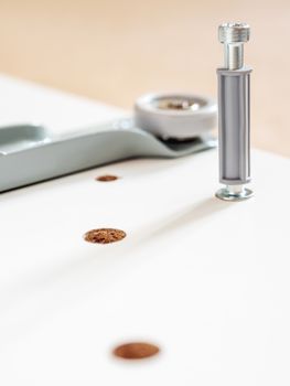 Self-assembly of furniture. The fasteners are installed in the drilled hole. DIY interior.