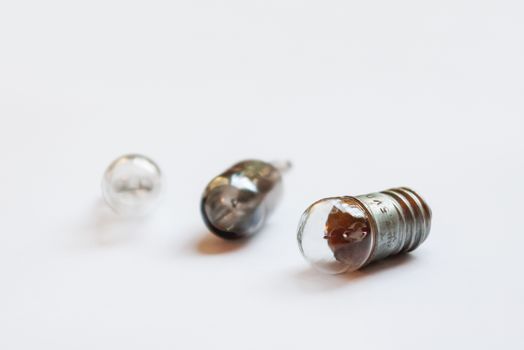 Small old light bulbs. Three incandescent lamps on white background.