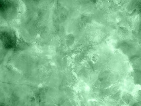 Concrete texture of neo mint colored wall with chaotic circular marks building tool. Decorative traces of the trowel to the wall. Fashionable interior decoration.