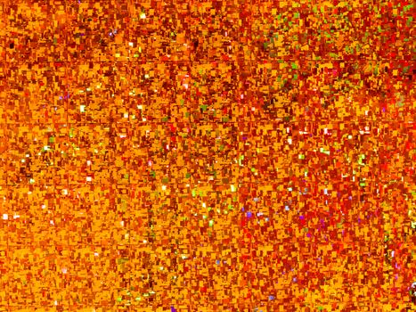 Bright golden background. Shiny and sparkling holographic orange backdrop. Top view, flat lay.