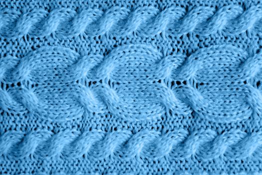Abstract knitted background. Blue woolen sweater texture. Close up picture of knitted pattern.