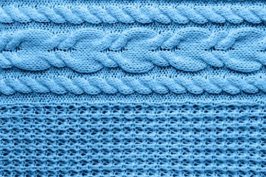 Abstract knitted background. Blue woolen sweater texture. Close up picture of knitted pattern.