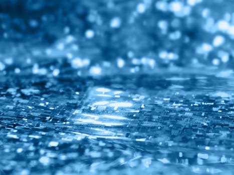 Classic blue sparkling background. Shiny and holographic blue backdrop.