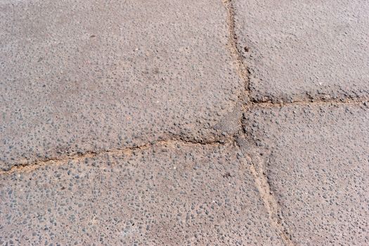 Crack in asphalt. Damaged pavement. Poor condition of the road surface.