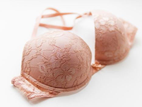 Beige lace bra on white background. Elegant underwear.