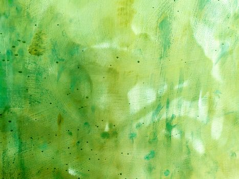 Green abstract metal background with scratches and stains. Colorful backdrop with blots and strokes.