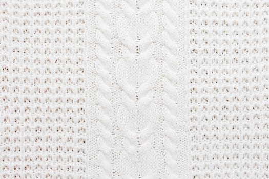 Abstract knitted background. Wool white sweater texture. Close up picture of knitted pattern.