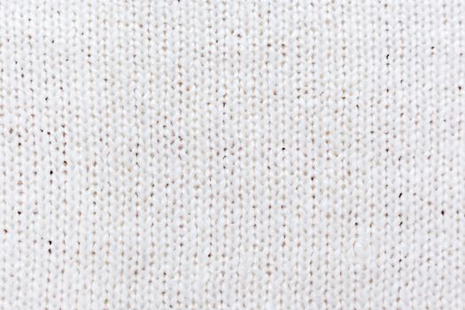 Abstract knitted background. Wool white sweater texture, close up.