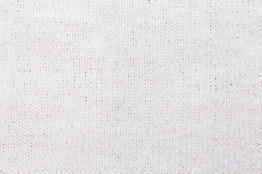 Abstract knitted background. Wool white sweater texture. Close up picture of knitted pattern.