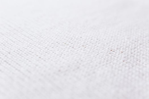 Abstract knitted background. Wool white sweater texture. Diagonal close up picture of knitted pattern.