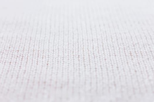 Abstract knitted background. Wool white sweater texture. Close up picture of knitted pattern.