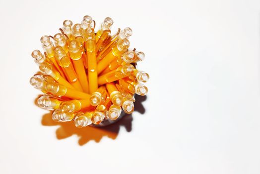 Bright yellow pens in pencil box on white background. Office supplies, top view.