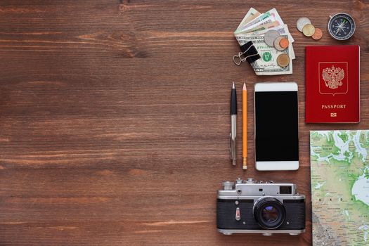 Travel background. Different things you need for journey - smartphone, passport, camera, map, money. Place for text.