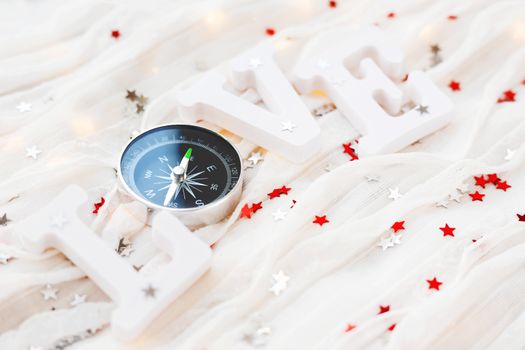 Love background. Travel symbol - compass and confetti on white fabric.