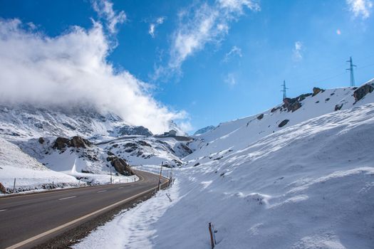 Alpine pass in switzerland, Julierpass in swiss alp with snow and cloudy sky