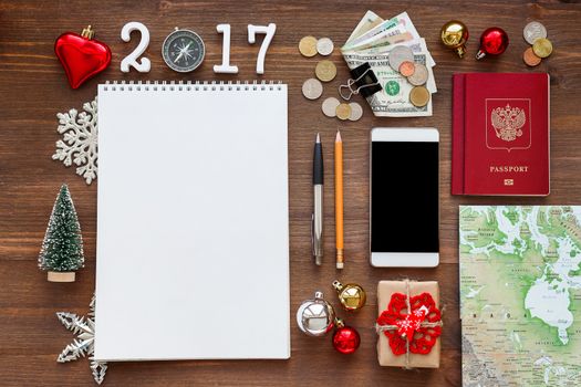 Travel background 2017 year. Planning winter Christmas and New Year vacations. Different things you need for journey - smartphone, passport, map, money, notepad.