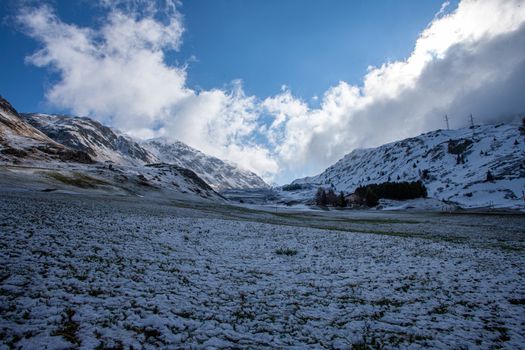 Alpine pass in switzerland, Julierpass in swiss alp with snow and cloudy sky