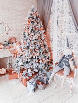 Christmas and New Year Eve Tree. Holiday winter background. Interior details - mirror-snowflake, mantelpiece with garland of light bulbs, many presents and elf with gifts.