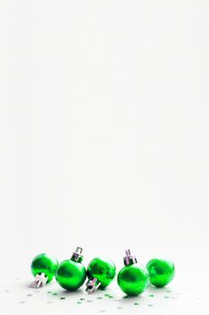 Christmas and New Year background with green decorative balls for Christmas tree. Place for text.